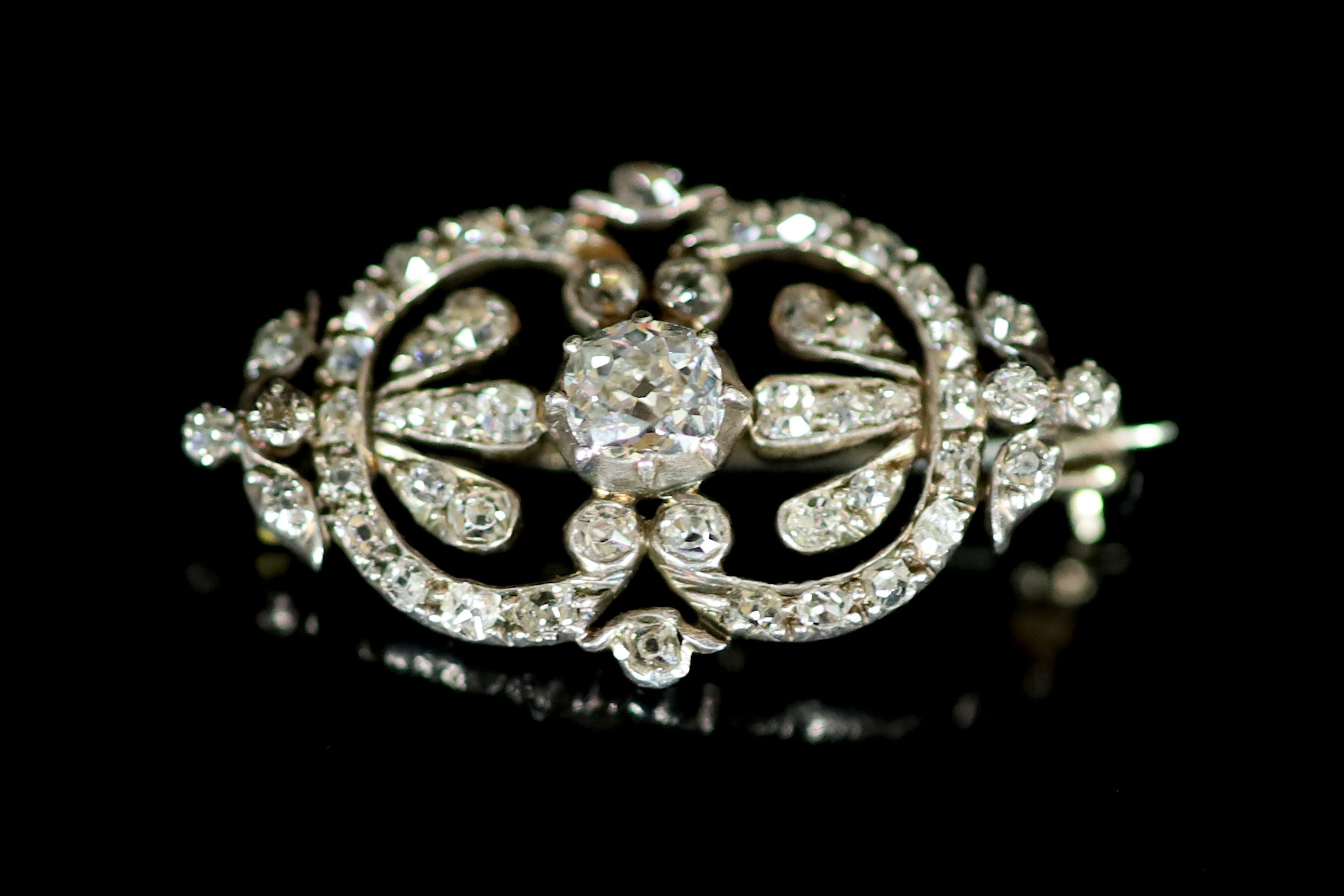 An Edwardian gold, silver and diamond set openwork oval brooch